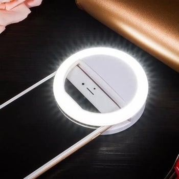 the selfie ring light clipped onto a smartphone