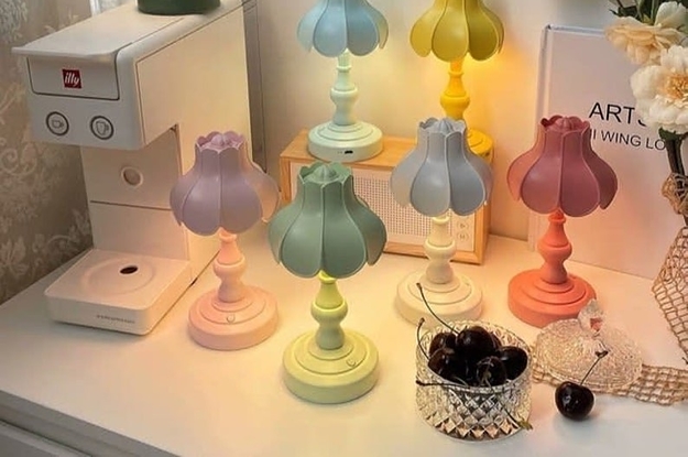 six pastel colored lamps on a white desk