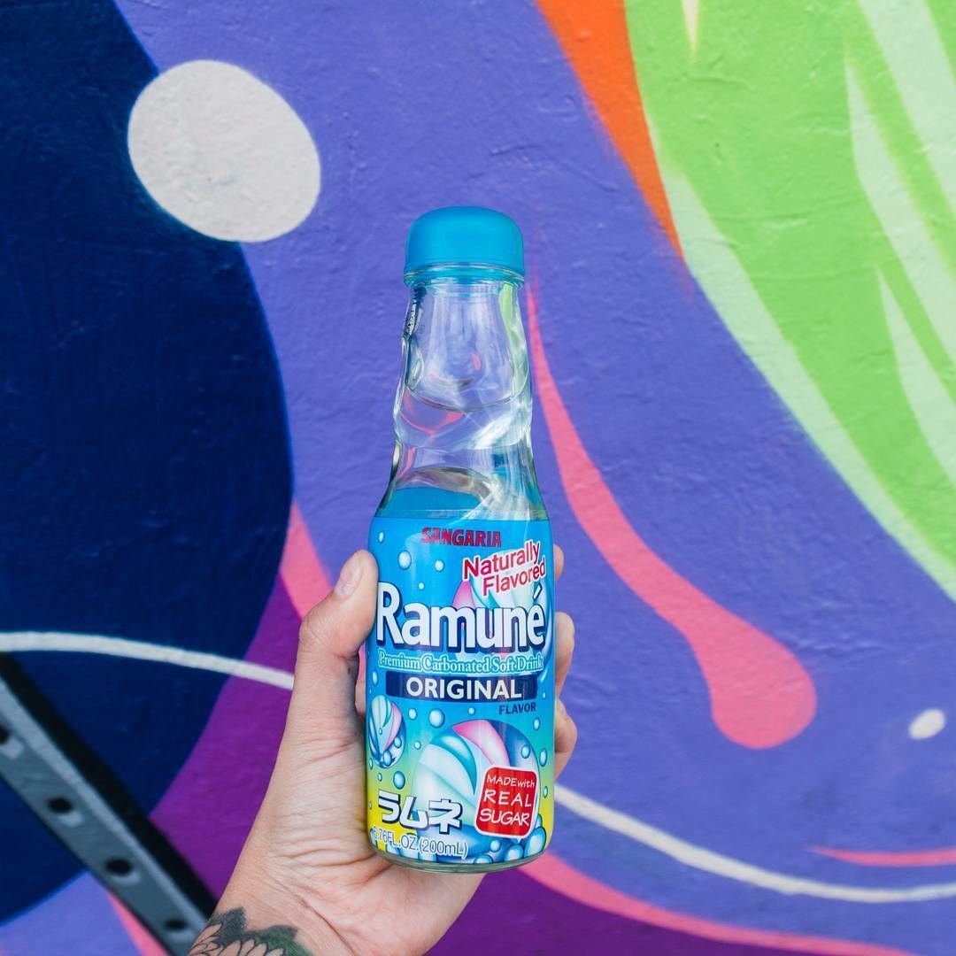 A model holding the Ramune soda