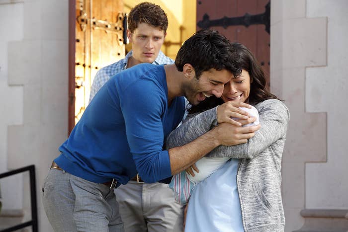 jane, michael, and rafael hugging baby