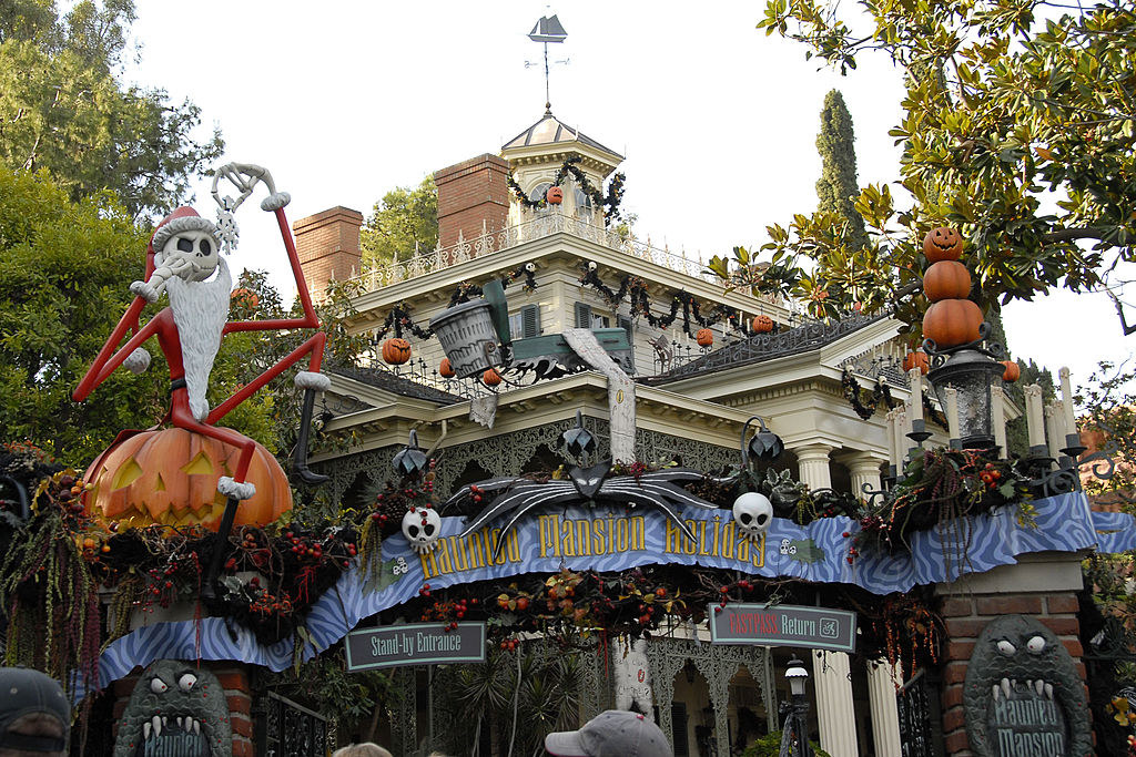 Exterior of Haunted Mansion in Disneyland, Jack Skellington sitting on a Jack O Lantern at the entrance