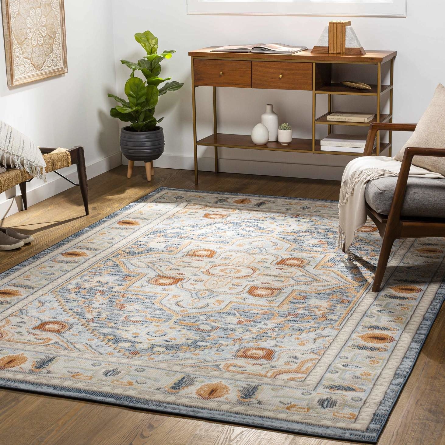 the blue, orange, gold, and cream area rug in a living room