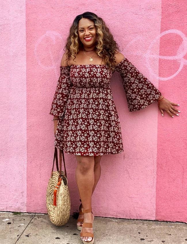 Reviewer wearing the maroon off-the-shoulder ruched mini-dress