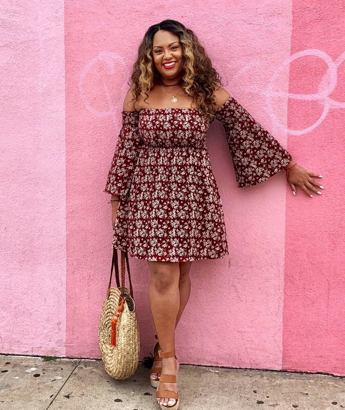 Reviewer wearing the maroon off-the-shoulder ruched mini-dress