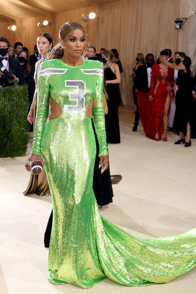 Ciara wears a long sleeve glittery gown with a football jersey number on the bodice