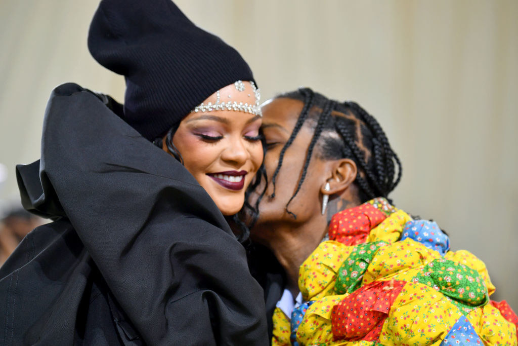 A close up of ASAP Rocky giving Rihanna a kiss on the cheek