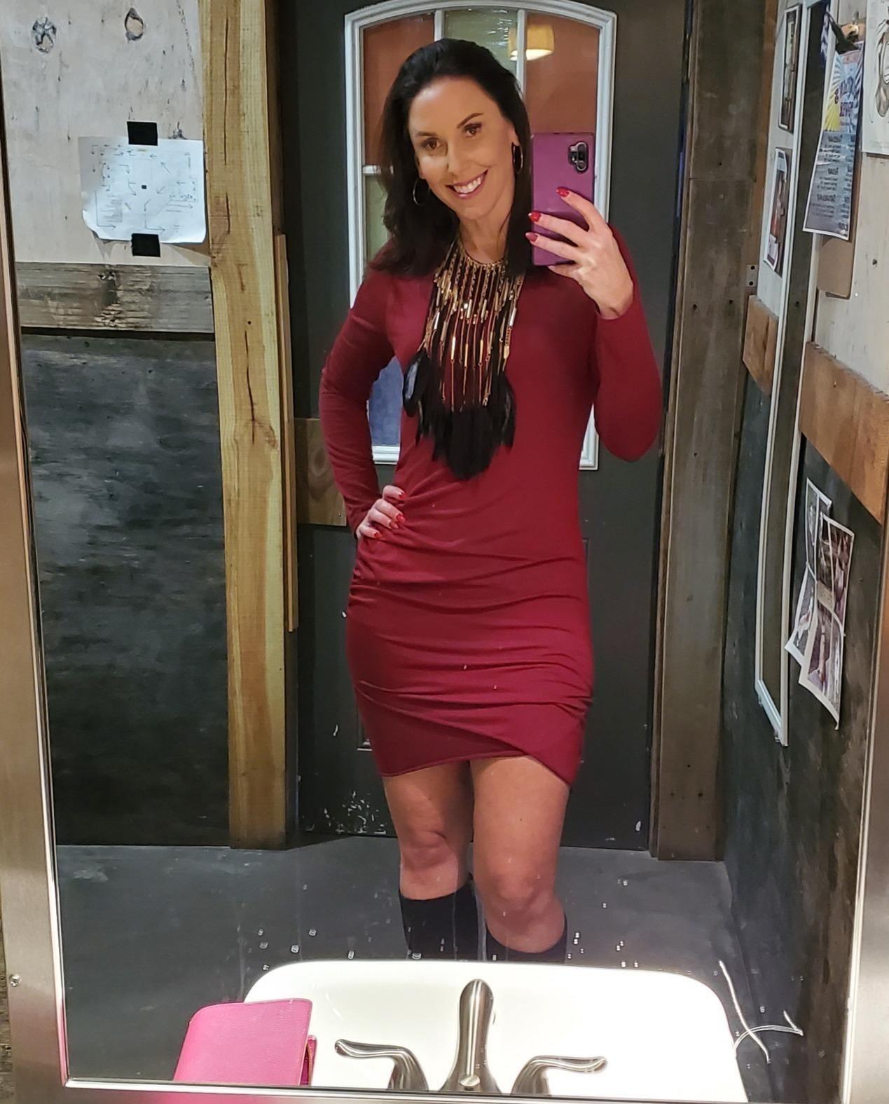 Reviewe wearing the wine red ruched bodycon long-sleeve wrap dress