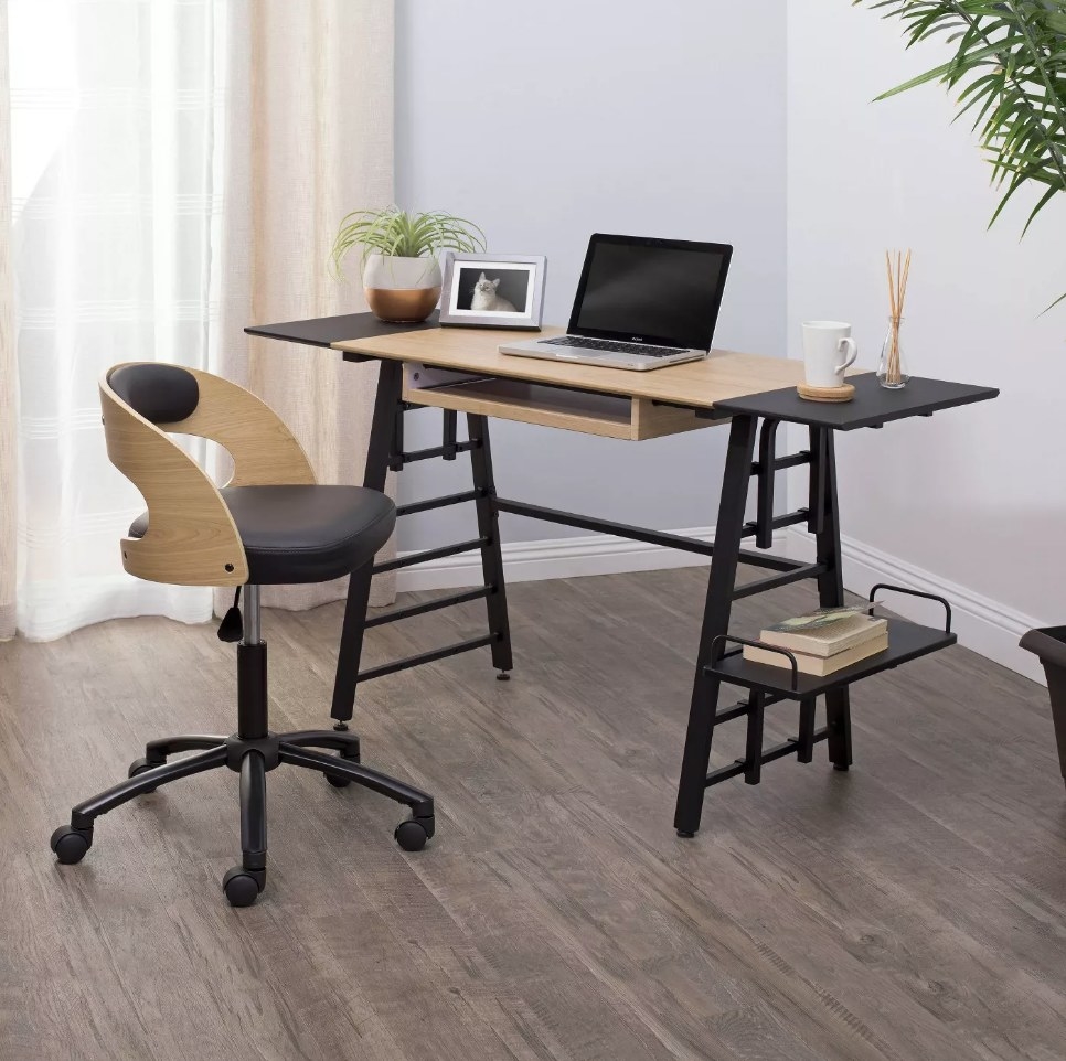 Black and wooden desk with collapsible black side panels
