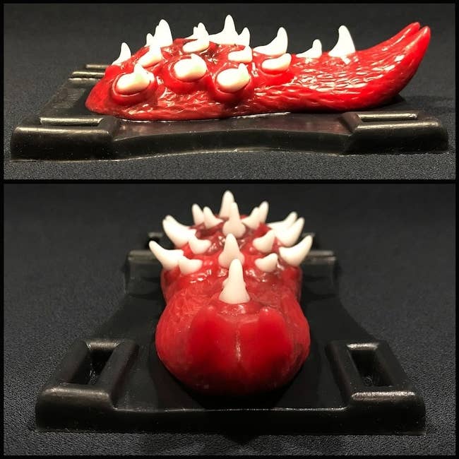 Black and red tongue-shaped grinding toy from different angles