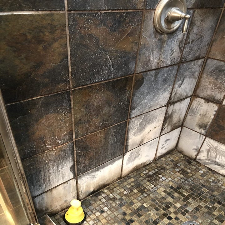 reviewer's shower tile with huge white stain
