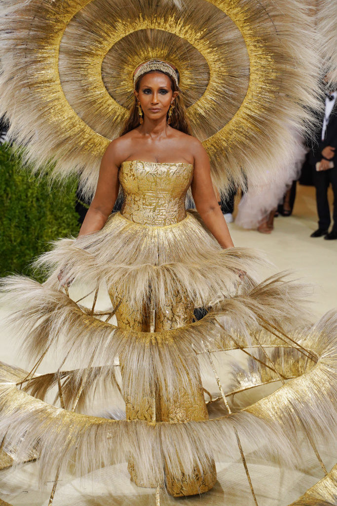 Iman wore an elaborate metallic strapless jumpsuit with a feathered skirt and matching headdress