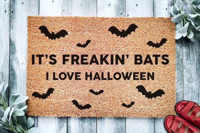 a doormat with bats and lettering that reads 