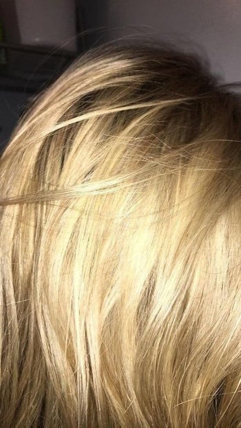 A reviewer with yellow-tone blonde hair