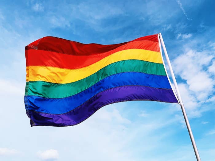 The six color rainbow pride flag blowing in the wind