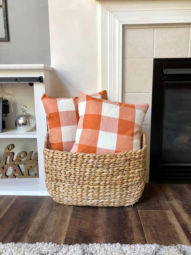 reviewer's pillow in orange and white plaid in a basket