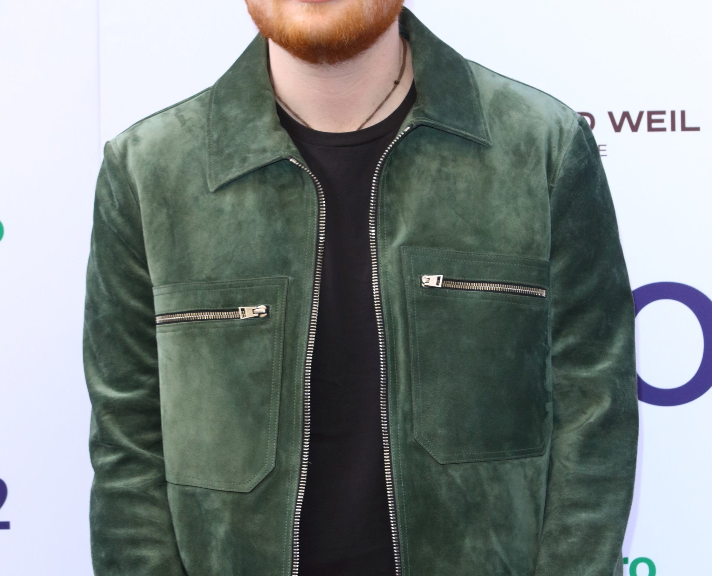 Ed wears a green suede jacket with pocket zippers to an award show