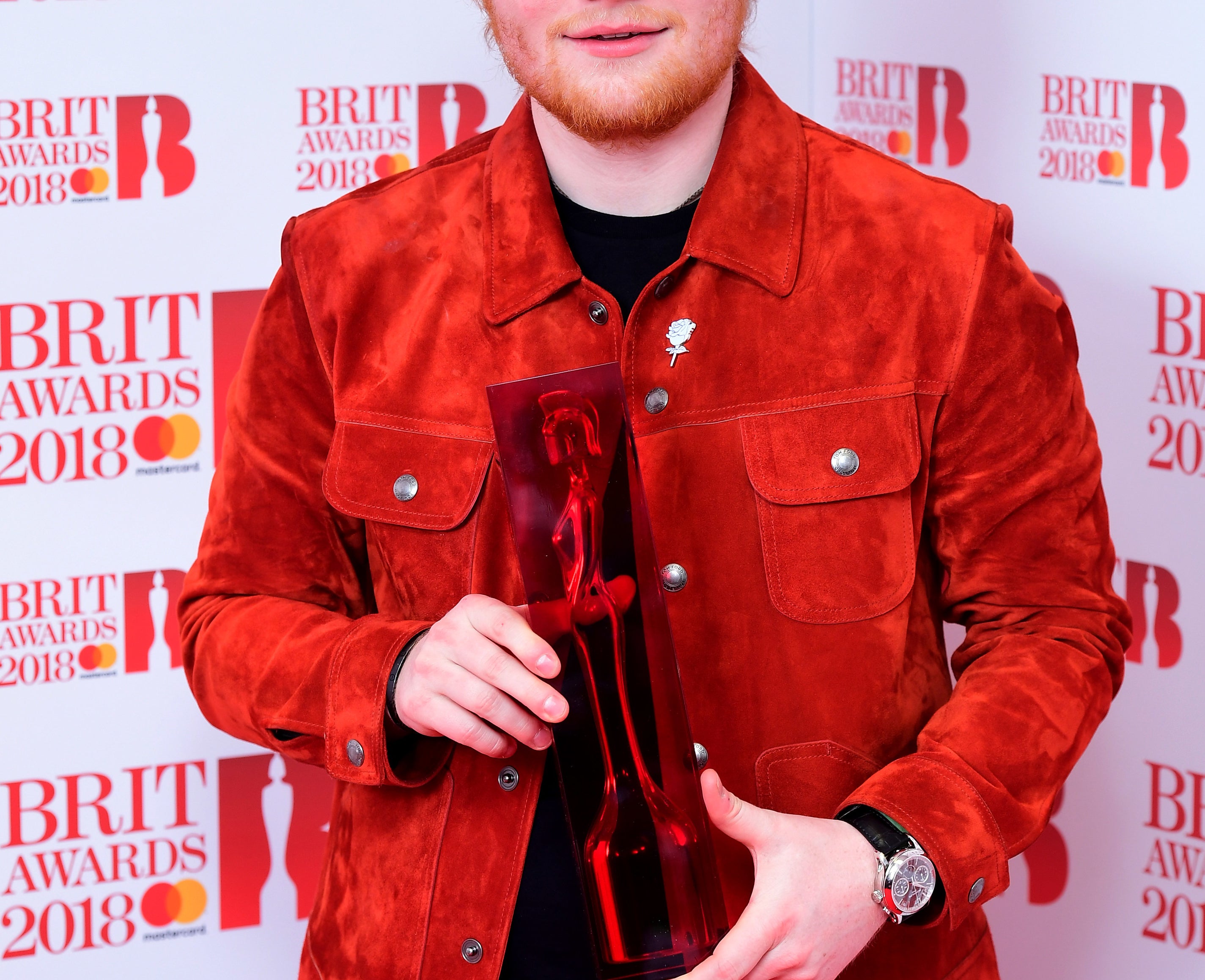 Ed holds up an award at the Brits