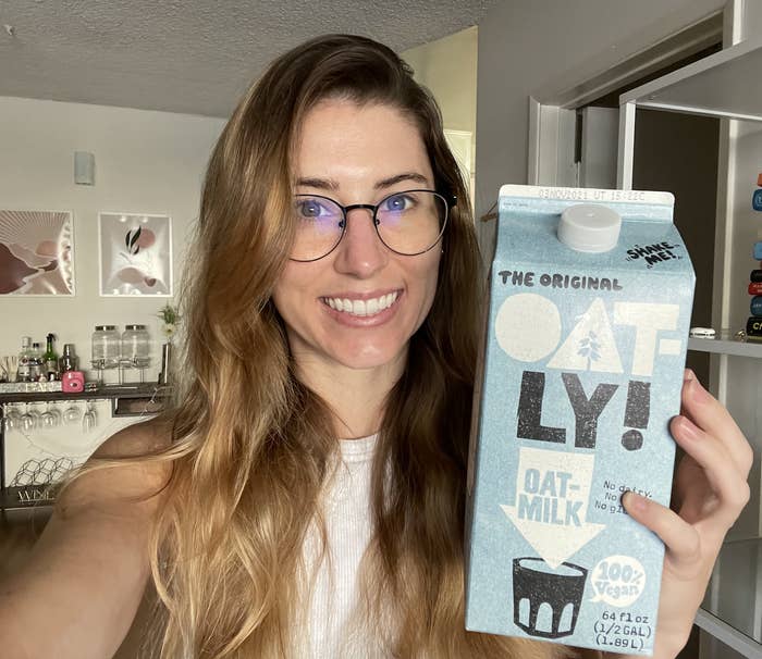 Farrah posing with Oatly carton