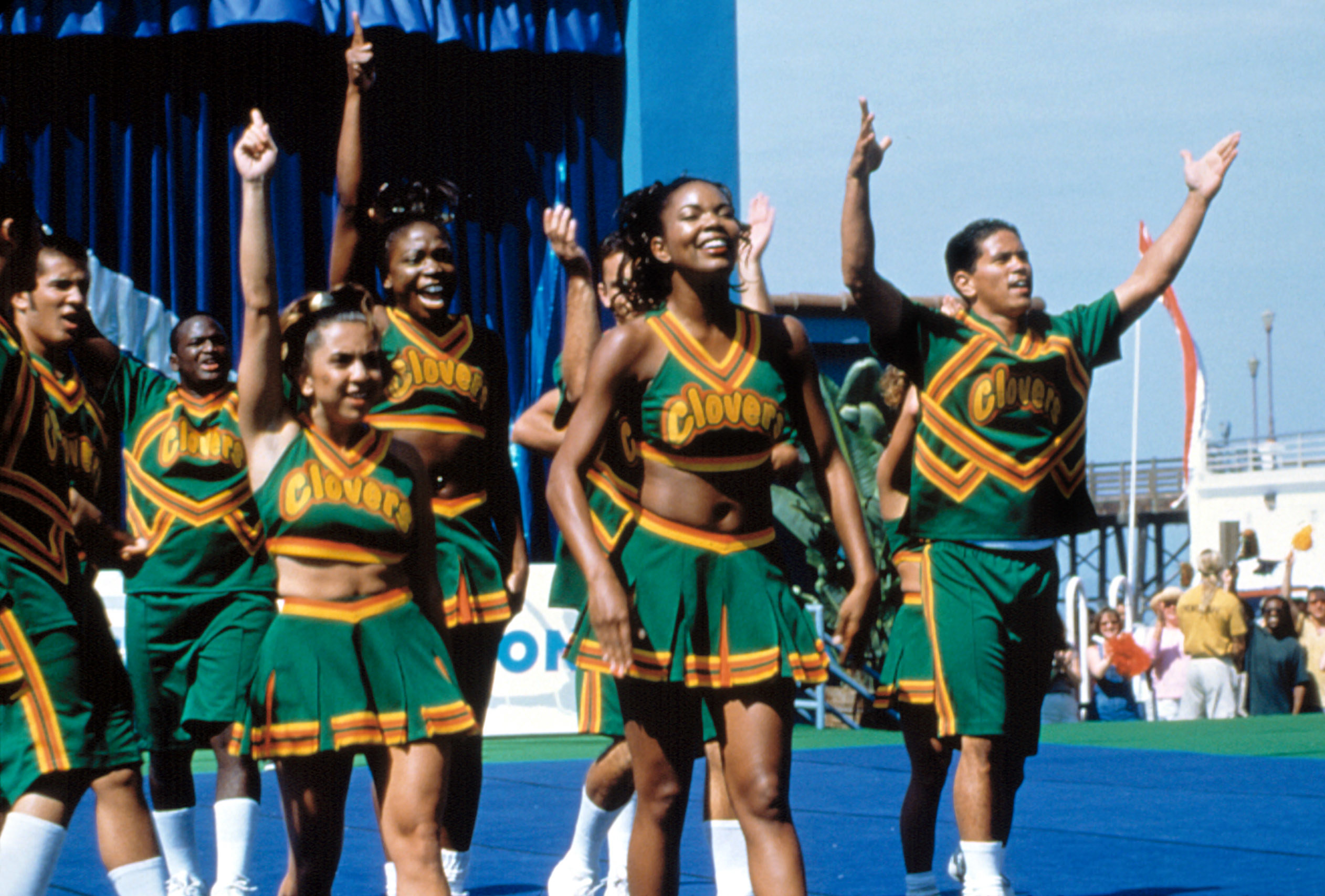 Gabrielle and her teammates cheer while walking out onto a field