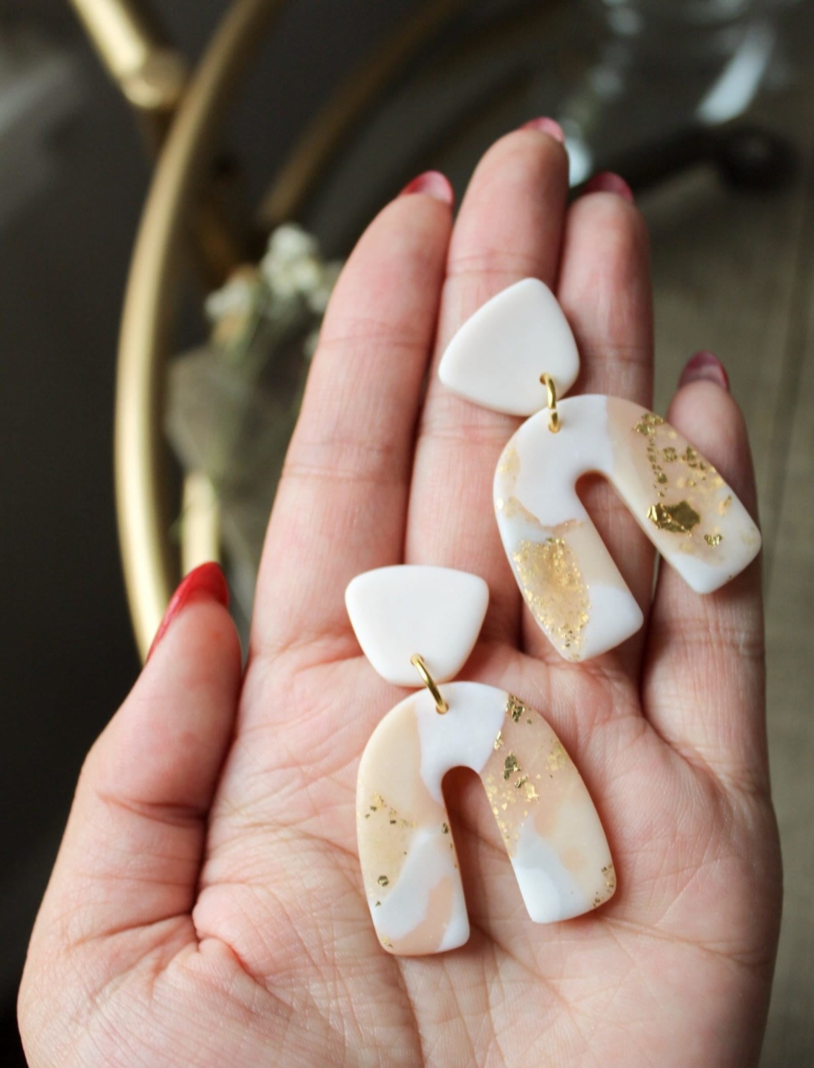 the white and blush marble earrings with gold foil details