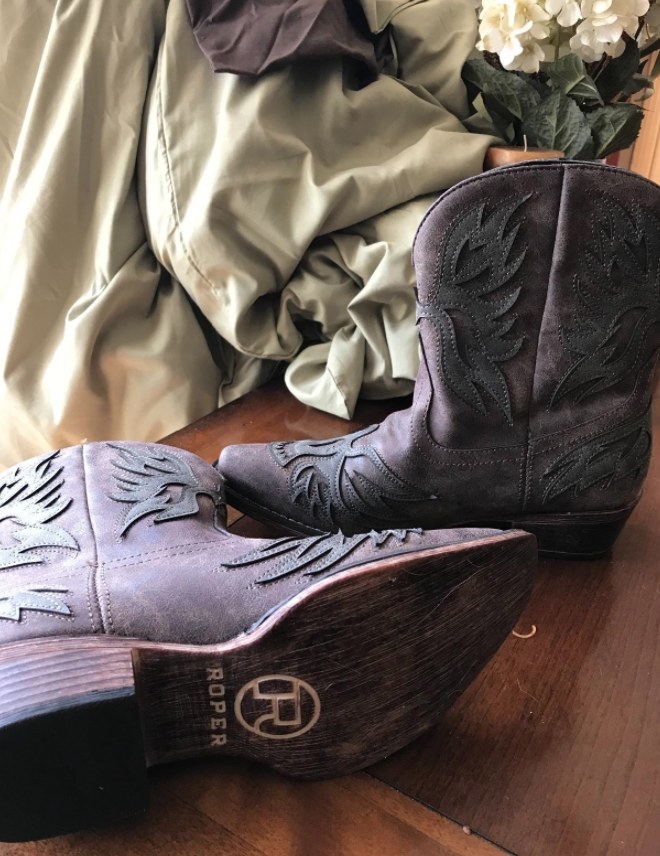 the cowboy boots showing the bottom which says &quot;roper&quot;