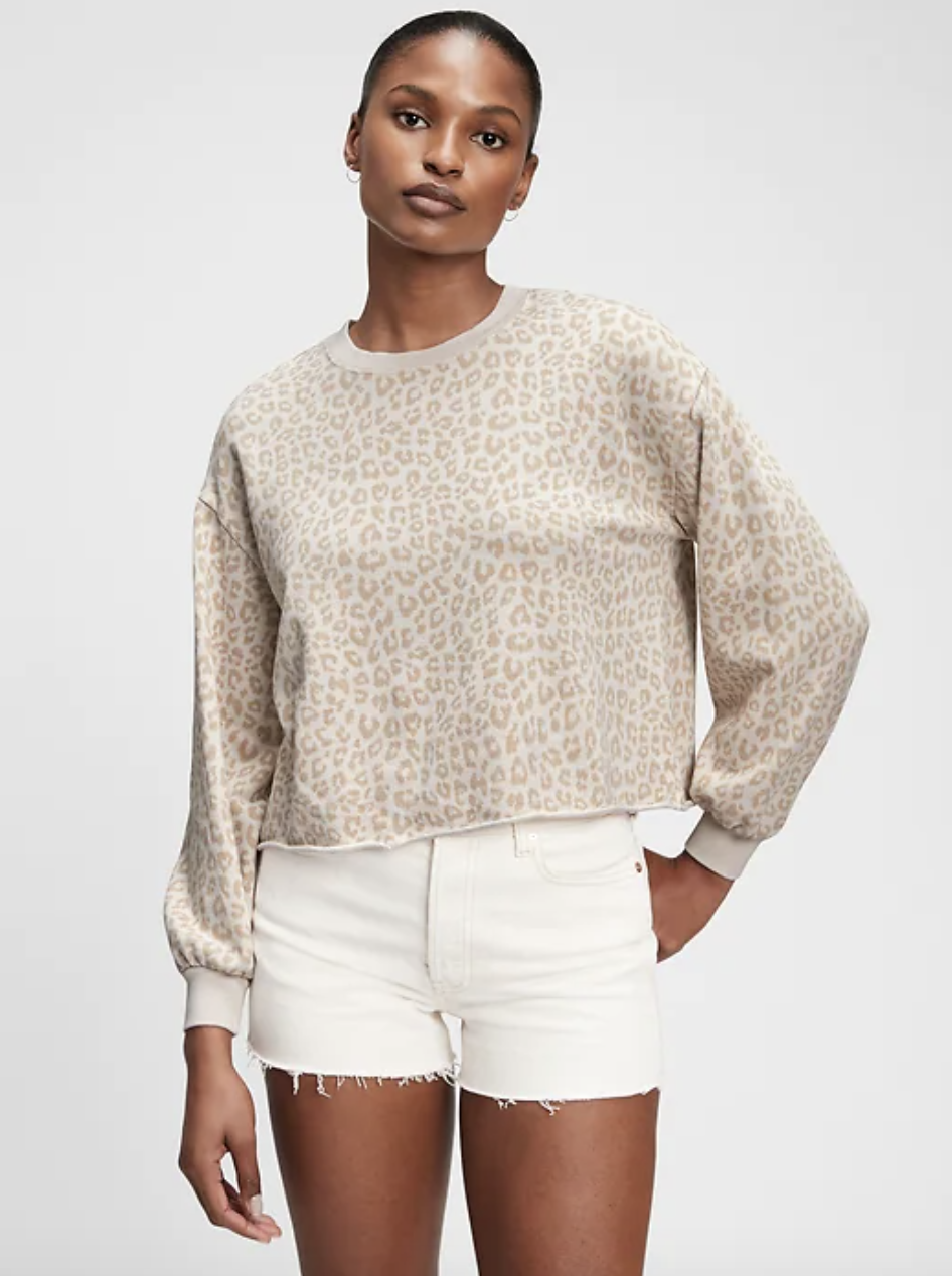 model wearing beige and white leopard print sweatshirt