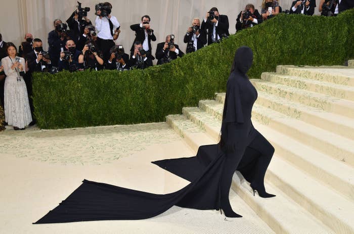 Kim&#x27;s black ensemble, with long train, on the Met Gala steps