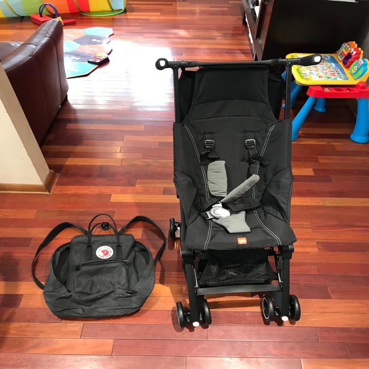 reviewer's travel stroller popped up and next to a backpack