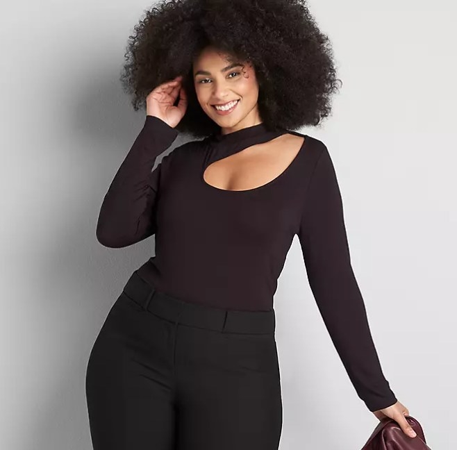 Model wearing black turtleneck with cutout and black pants