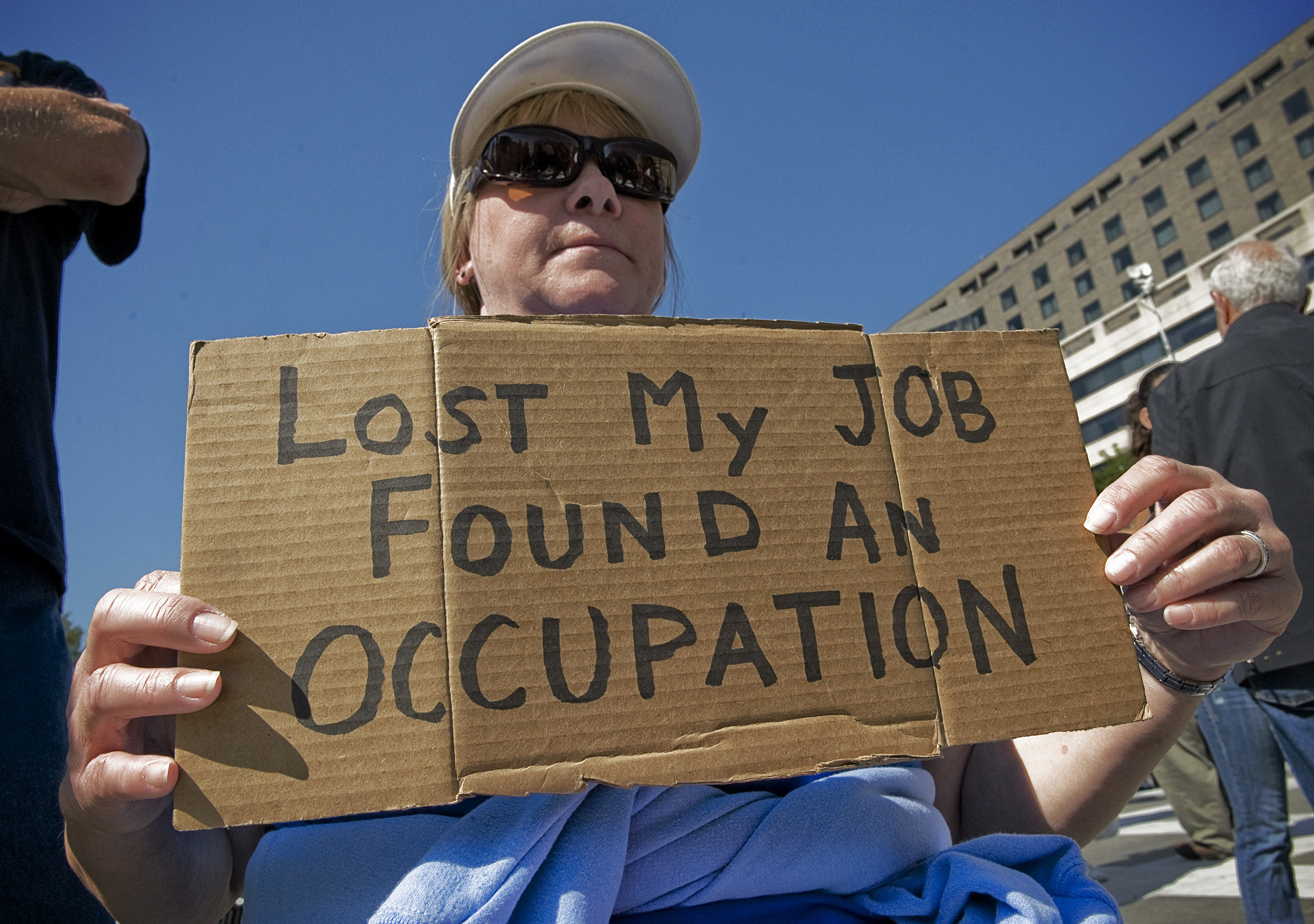 Sign reads &quot;lost my job found an occupation&quot;