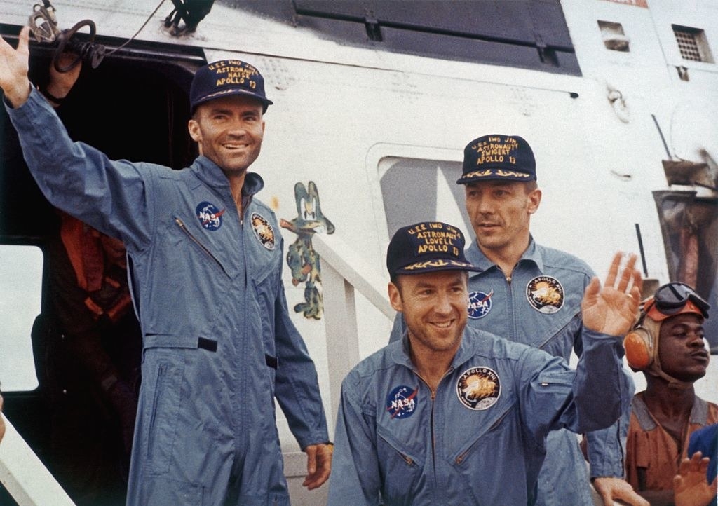 Fred Haise, Jack Swigert, and Jim Lovell wearing NASA uniforms in real life
