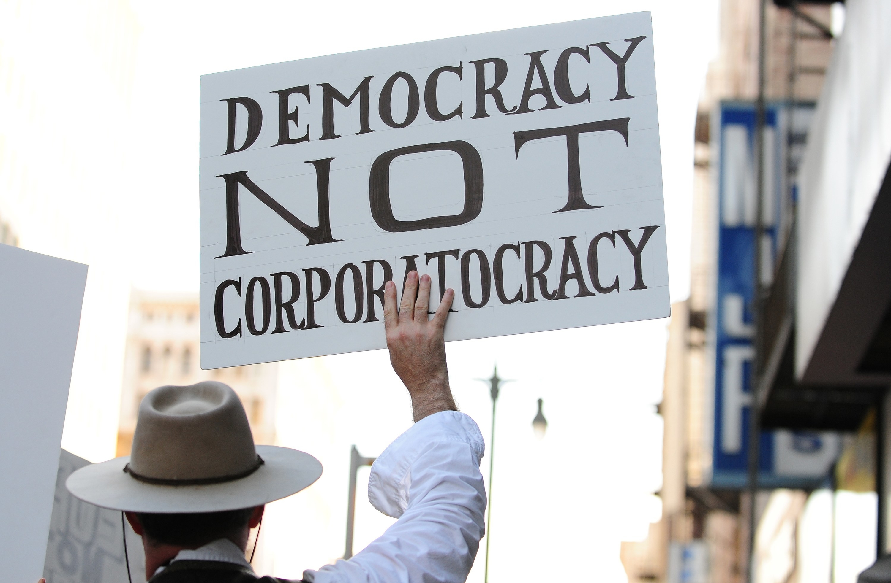 The sign that reads &quot;Democracy Not Corporatocracy&quot;