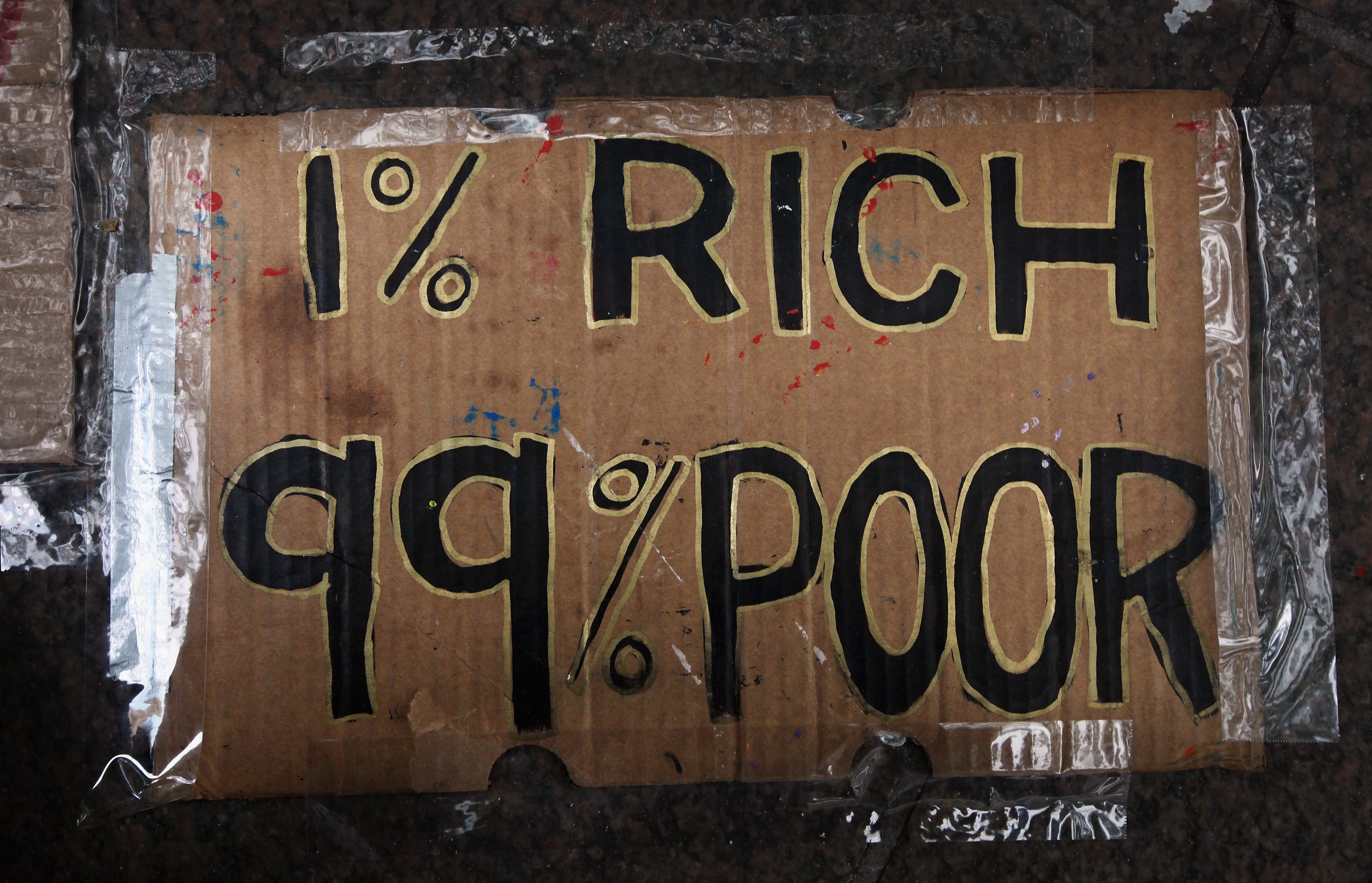 Sign reads 1% Rich 99% Poor