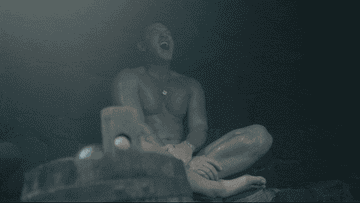 Lars sitting cross-legged in a sauna screaming