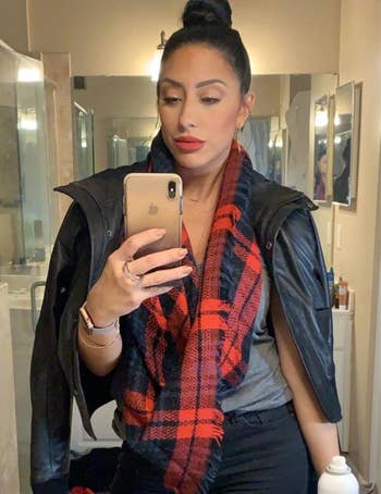 a reviewer wearing a red and blue plaid scarf