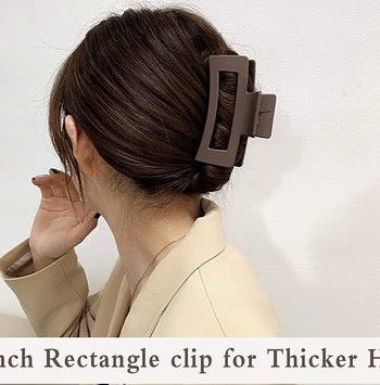 a model wearing a brown claw clip