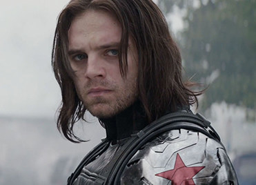 Bucky Barnes wearing a black vest and metal arm showing