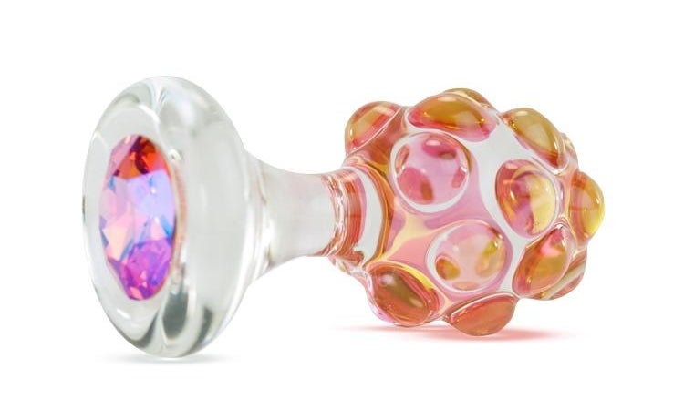 Glass plug with pink bejeweled base and yellow and pink bump texture on shaft