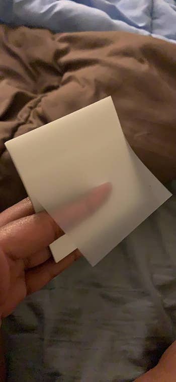 Reviewer holding sticky notepad in hand