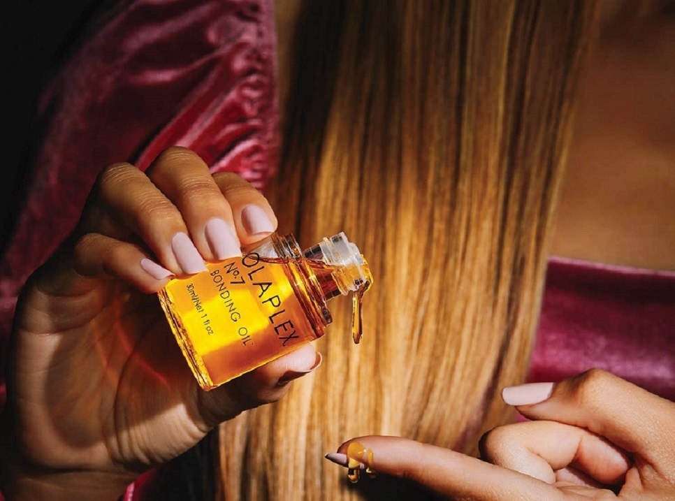 Persona usando óleo extraordinario para cabello