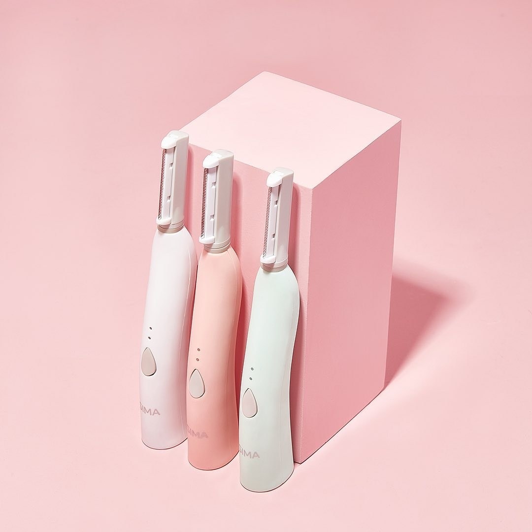 Three Sima tools in white, pink, and mint against pink background