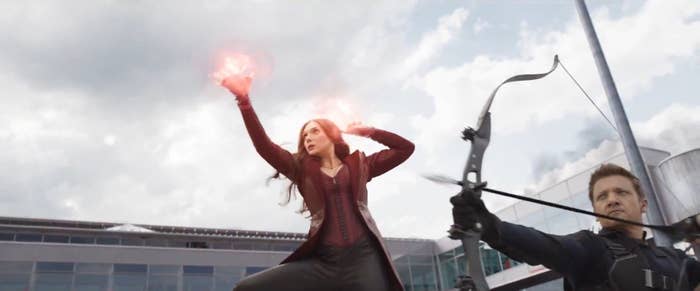 Wanda Maximoff shows off a ball of energy in her hands while Hawkeye gets ready to shoot an arrow from his bow