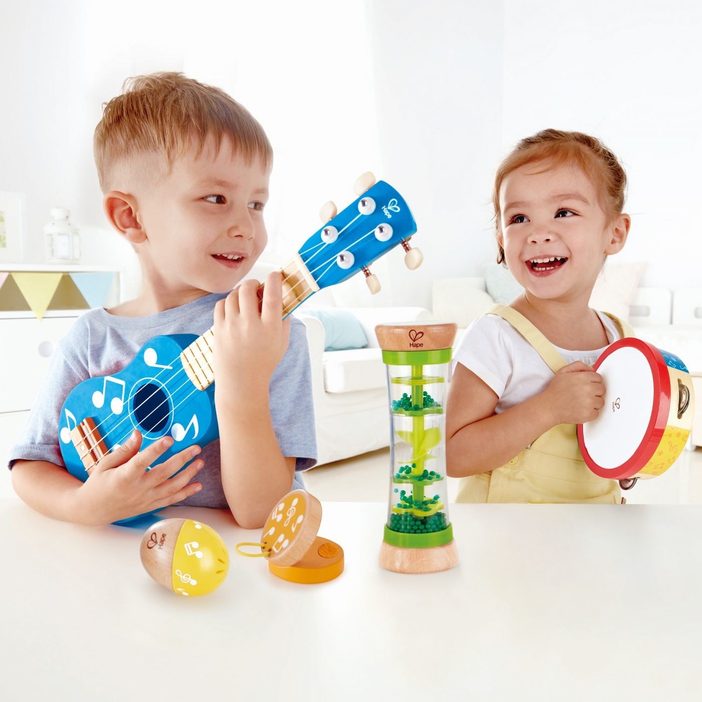 Two kids playing colorful musical instruments