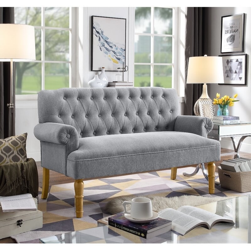 the gray couch with walnut legs in a living room
