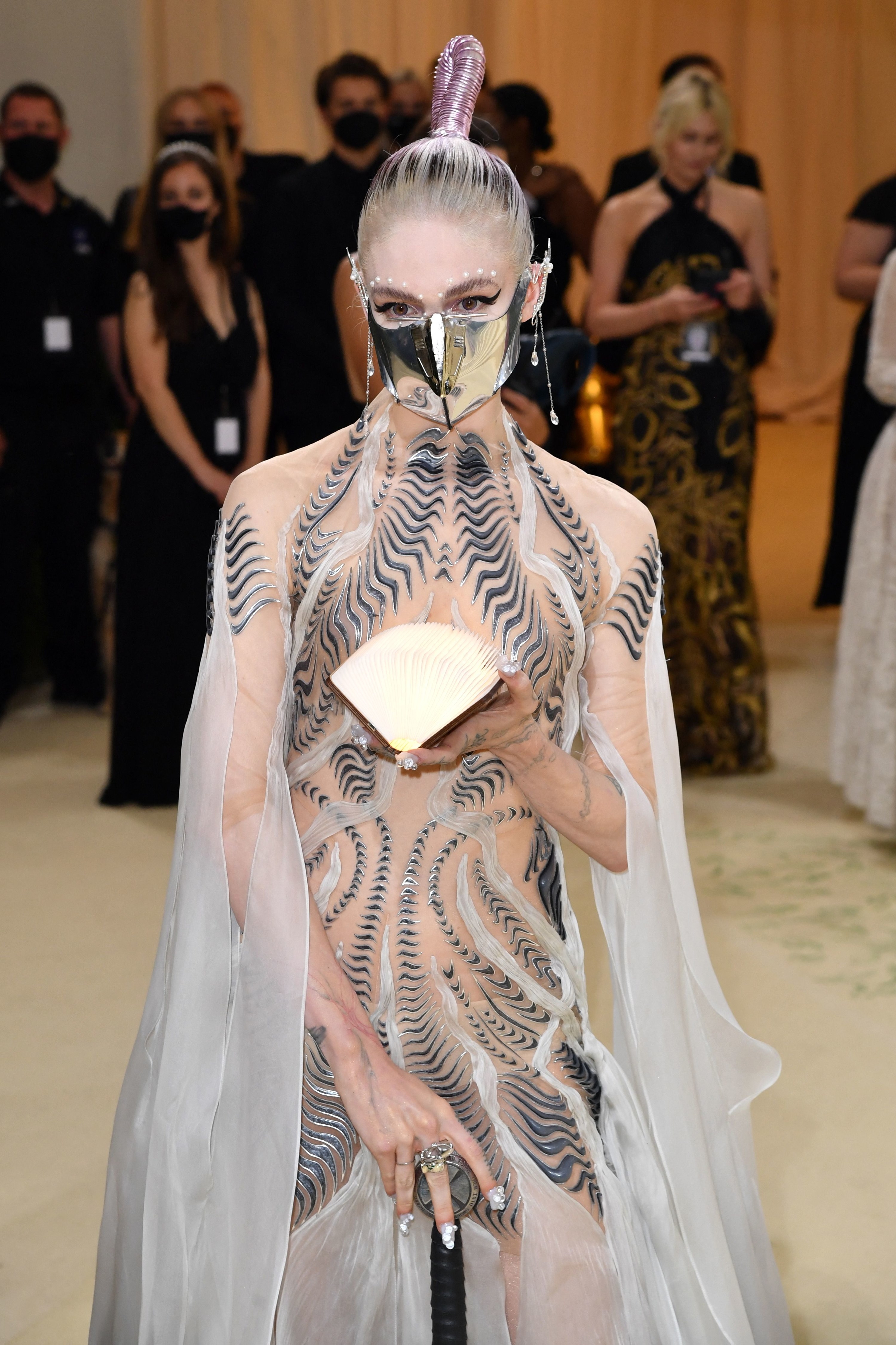 Grimes holds an open book on the carpet