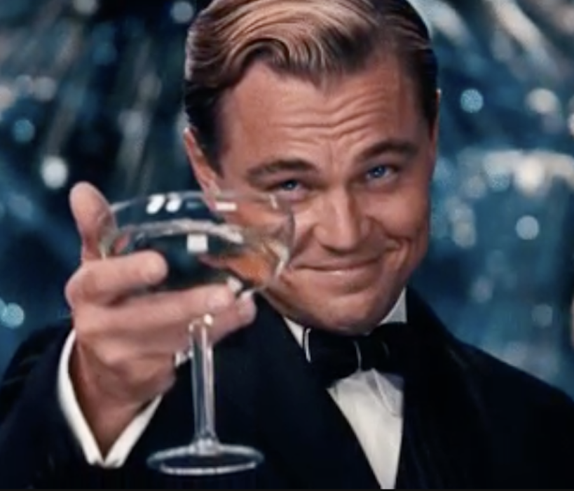 Leonardo DiCaprio in &quot;The Great Gatsby&quot; holding up a champagne glass in celebration