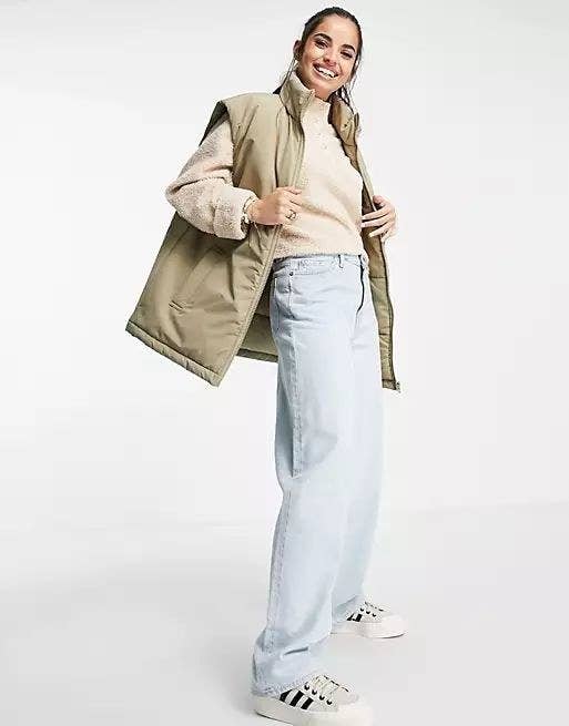 Model wearing the mid-thigh length vest