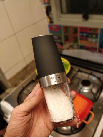 Reviewer is holding one of the grinders with salt in it