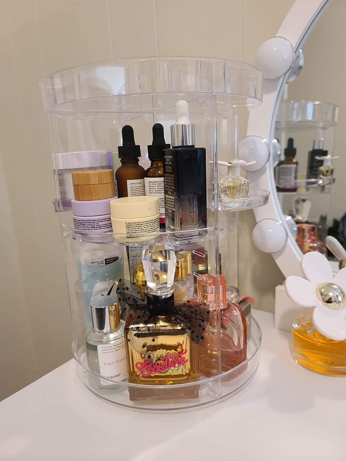 Reviewer photo of the clear acrylic spinning organizer with beauty products on it
