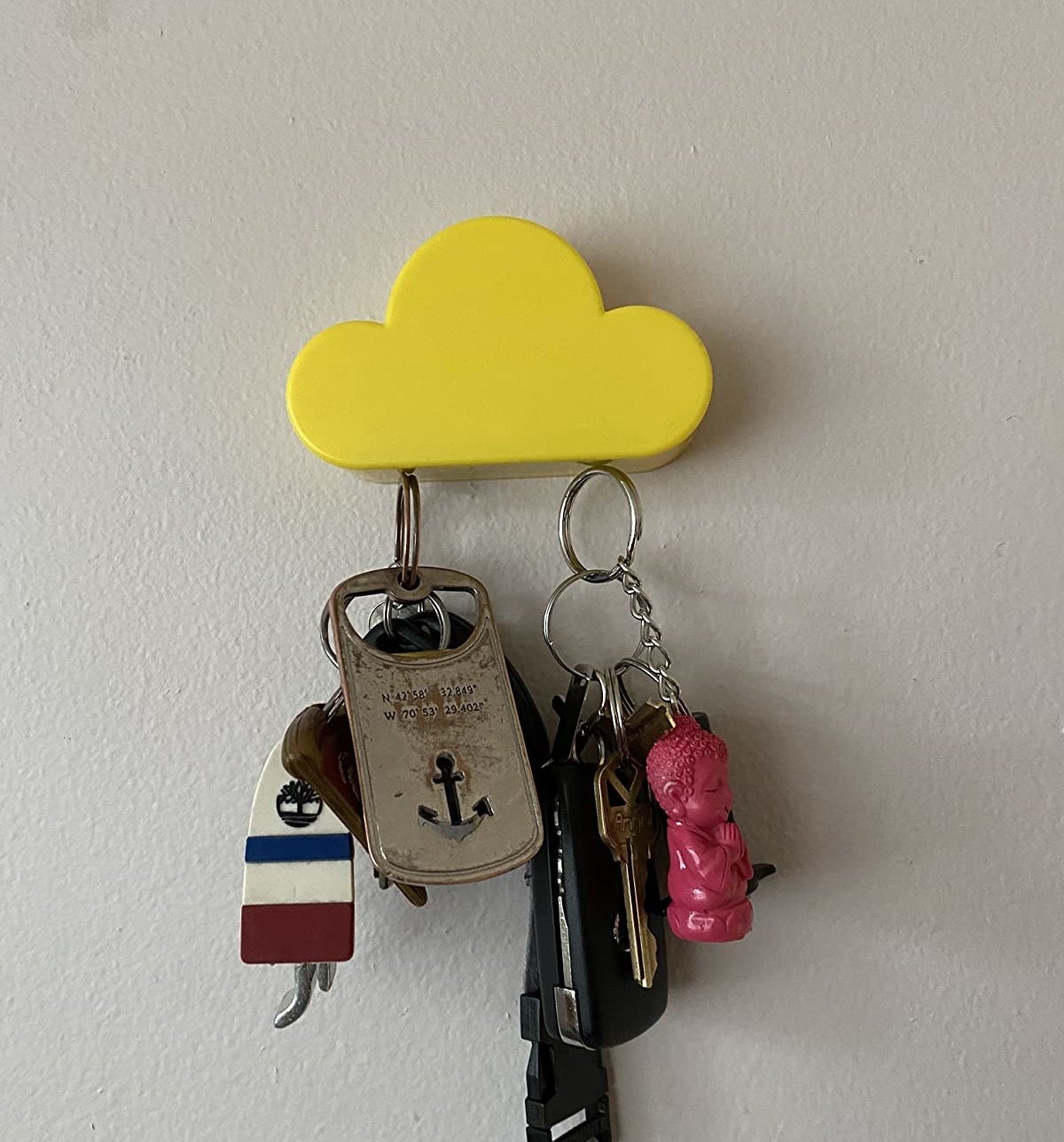 Reviewer photo of the yellow cloud magnetic key holder with keys on it